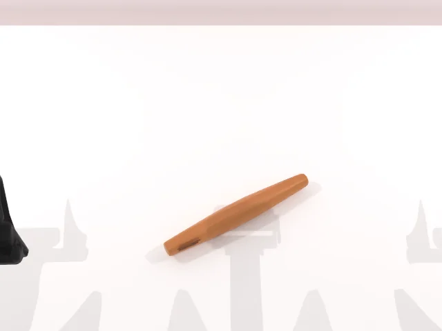 Simulator RGB from the head camera, frame 1 of 32 (reach), default appearance: a wooden roller on a white table.